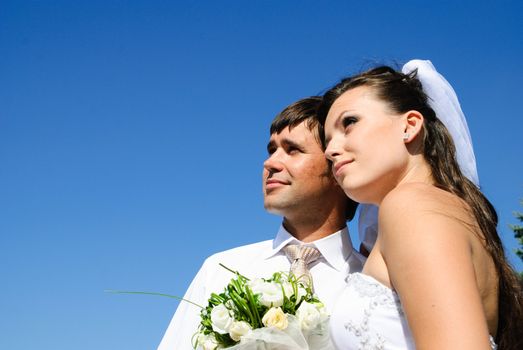 bride and groom and blue sky on the background