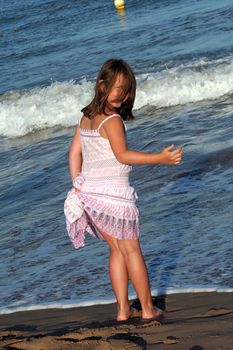 the little girl standing on the beach