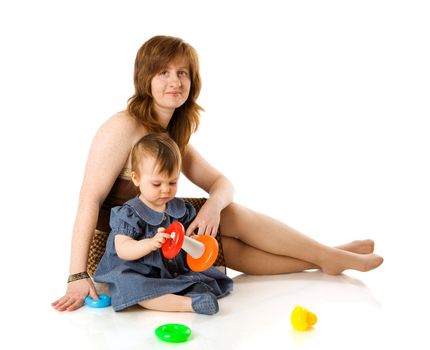 Mother playing with baby girl sitting isolated on white