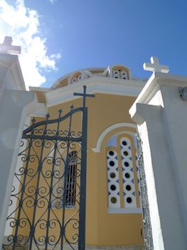 colorful Greek cathedral with an open gate