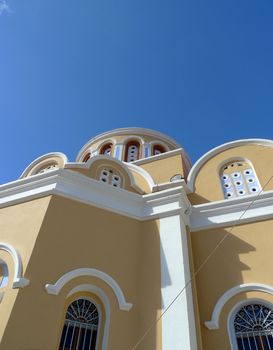 view of a bright greek cathedral from below