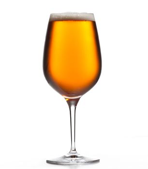 Chilled isolated wine goblet with small droplets of condensation on the outside of the glass and filled with golden colored beer