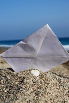 close-up of a envelope stuck in sand