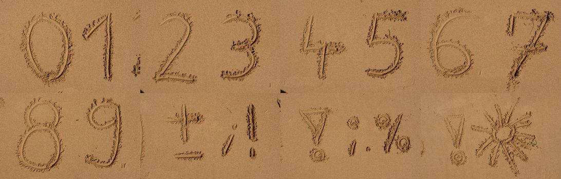 The alphabet written in sand on a beach.