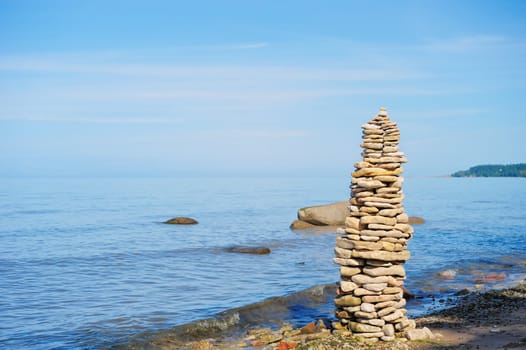 Pile of pebble as the tower on the sea coast