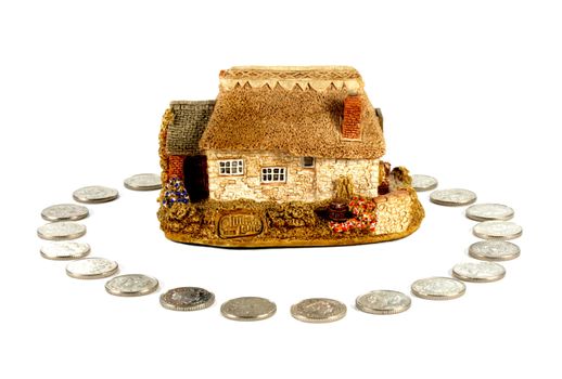 House home insurance concept coins surrounding a house