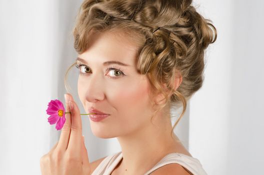 beauty woman closeup portrait with flower over grey background