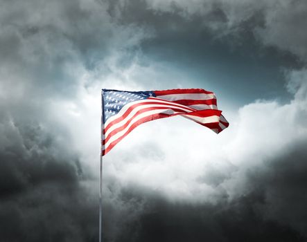 American flag on a dark cloudy dramatic sky