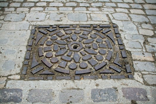 sewer's patch encircled of beautiful stones