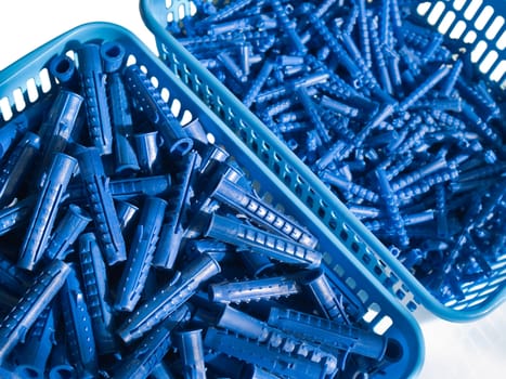 Blue plastic wall plugs in box