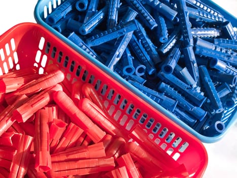 Blue and red plastic wall plugs in box