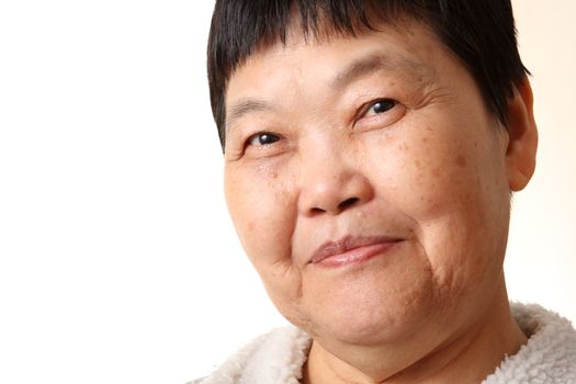 Studio Portrait Of Smiling Senior Woman 