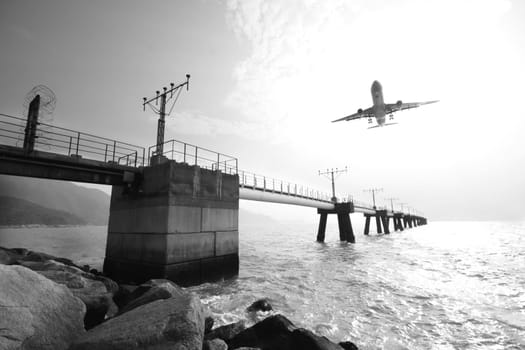 Plane is going to land in an airport. The plane is a bit in motion blur because of the speed. 