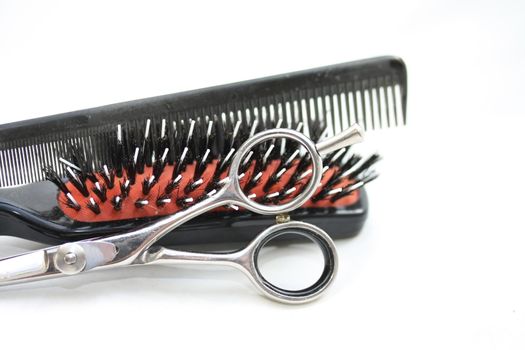 Basic Hairdressers tools - a brush, a comb  and a stainless steel pair of scissors