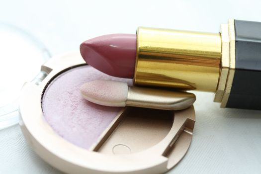 A solitaire pink eye shadow palet and a pink lipstick