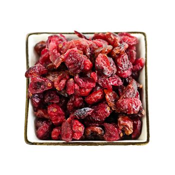 Bowl of dried cranberries isolated on white background