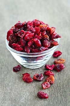 Dried cranberries spilling out of glass bowl