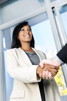 Portrait of black business woman shaking hands
