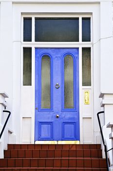 Blue front door with brass knocker in London England