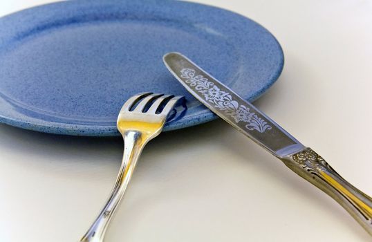 fork knife blue plate on a white background