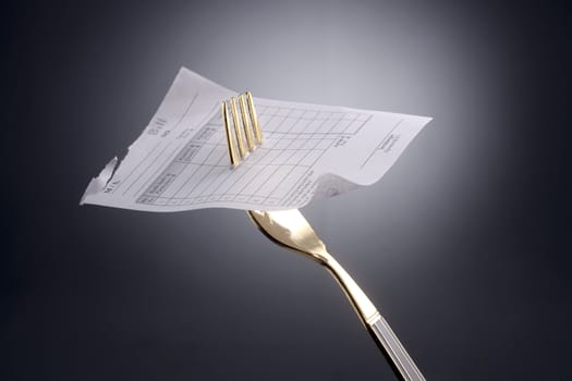 stock image of fork with the receipt on it