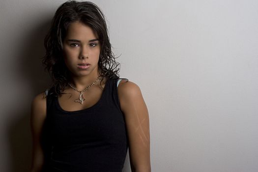 Young woman against a white wall with scares on her arm