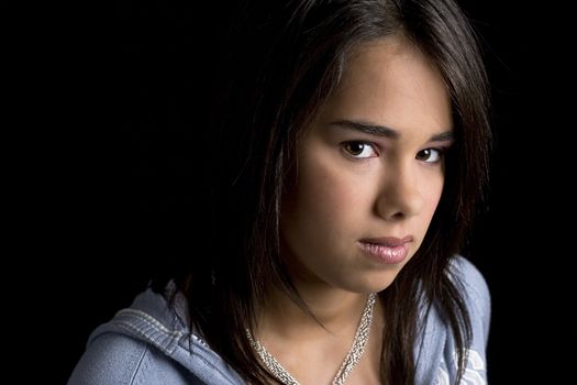 head shot of a teen girl against a black background