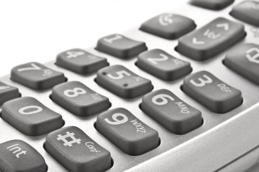 Close up of a silver grey telephone keypad with white background