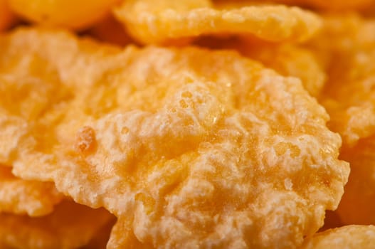 Goldish corn flakes. Macro with extremely shallow dof. Close-up of cornflakes.