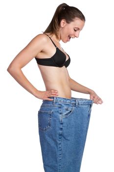Weight loss girl holding pants