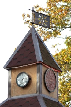 High resolution image. Ancient tower with hours. Weather vane on a tower roof.