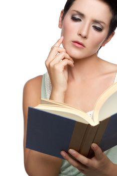 Thoughtful young woman reading book