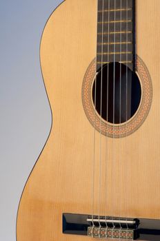 High resolution image.  Classical acoustic guitar, isolated on grey background.