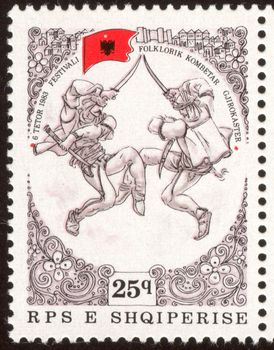 The scanned stamp. Dancers appear on stage. The Albanian stamp.