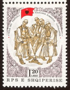 The scanned stamp. The Albanian stamp. The Albanian musicians appear on stage.