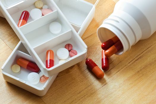 Pills, capsules and tablets sorted in medicine box for use as daily medication