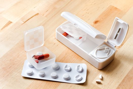 Blister with pills and travel pillbox with pillcutter 