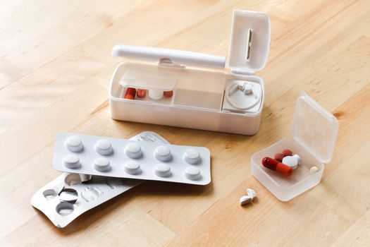 Blisters with pills and travel pillbox with pillcutter 