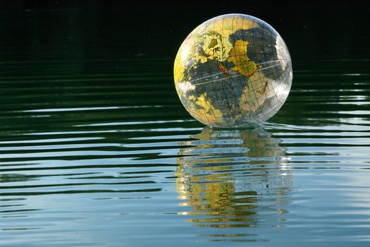 Globus ball on a lake on sunny day