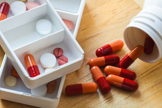 Tablets, capsules and pills sorted in medicine box for use as daily medication