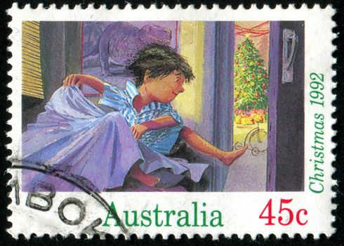 AUSTRALIA - CIRCA 1992: stamp printed by Australia, shows boy jumping from bed Christmas morning, circa 1992