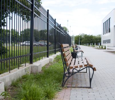 High resolution image. Bench in city street. City sidewalk.