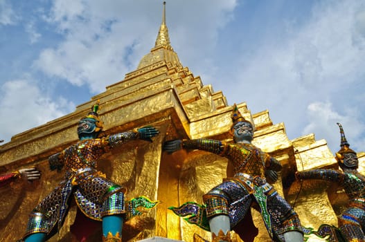 Giant Garuda statue and golden pagoda in Temple of The Emerald Buddha (Wat Phra Kaew), Bangkok, Thailand