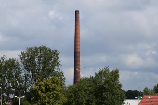 High resolution image. Factory pipe against the blue sky.