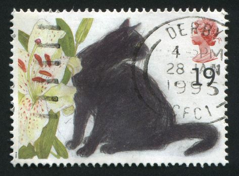 GREAT BRITAIN - CIRCA 1994: stamp printed by Great Britain, shows black cat sits near colours, circa 1994.