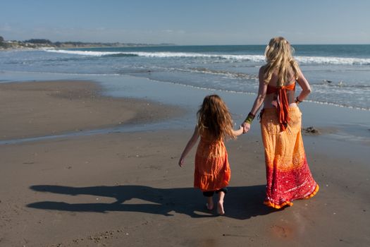 Mother Daughter at beach holding hands