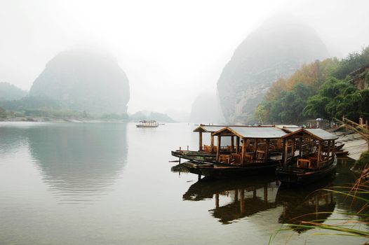 Landscape of tour boats at riverside in the rains