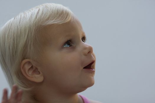 blond female toddler expressing wonder and looking up and right