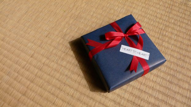 celebration gift with bright red  bow and 'heart-to-heart' words