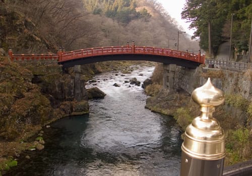 traditional sacred red bridge across mountain river in Nikko, Japan